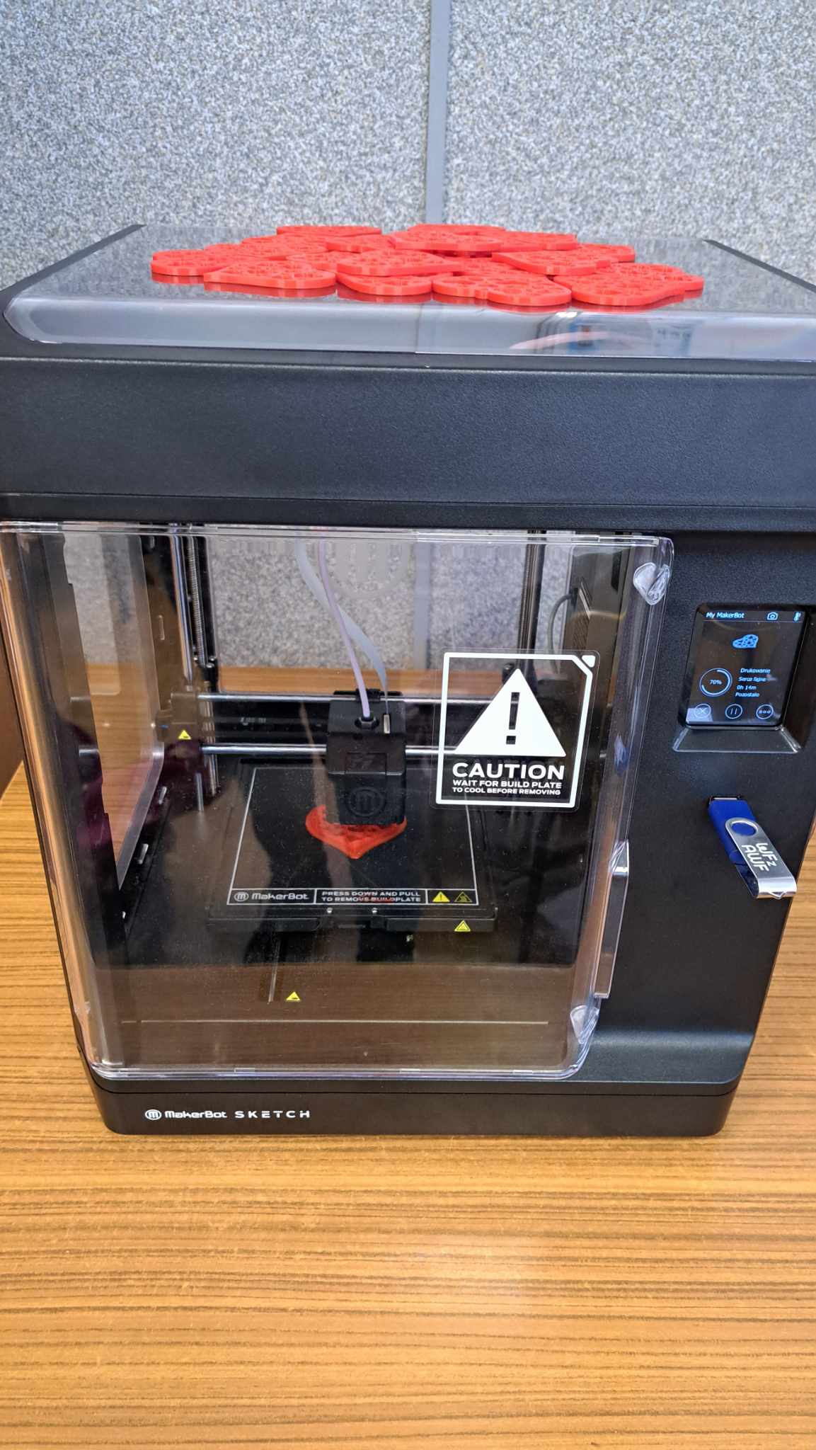 Zdjęcie przedstawia drukarkę 3D.